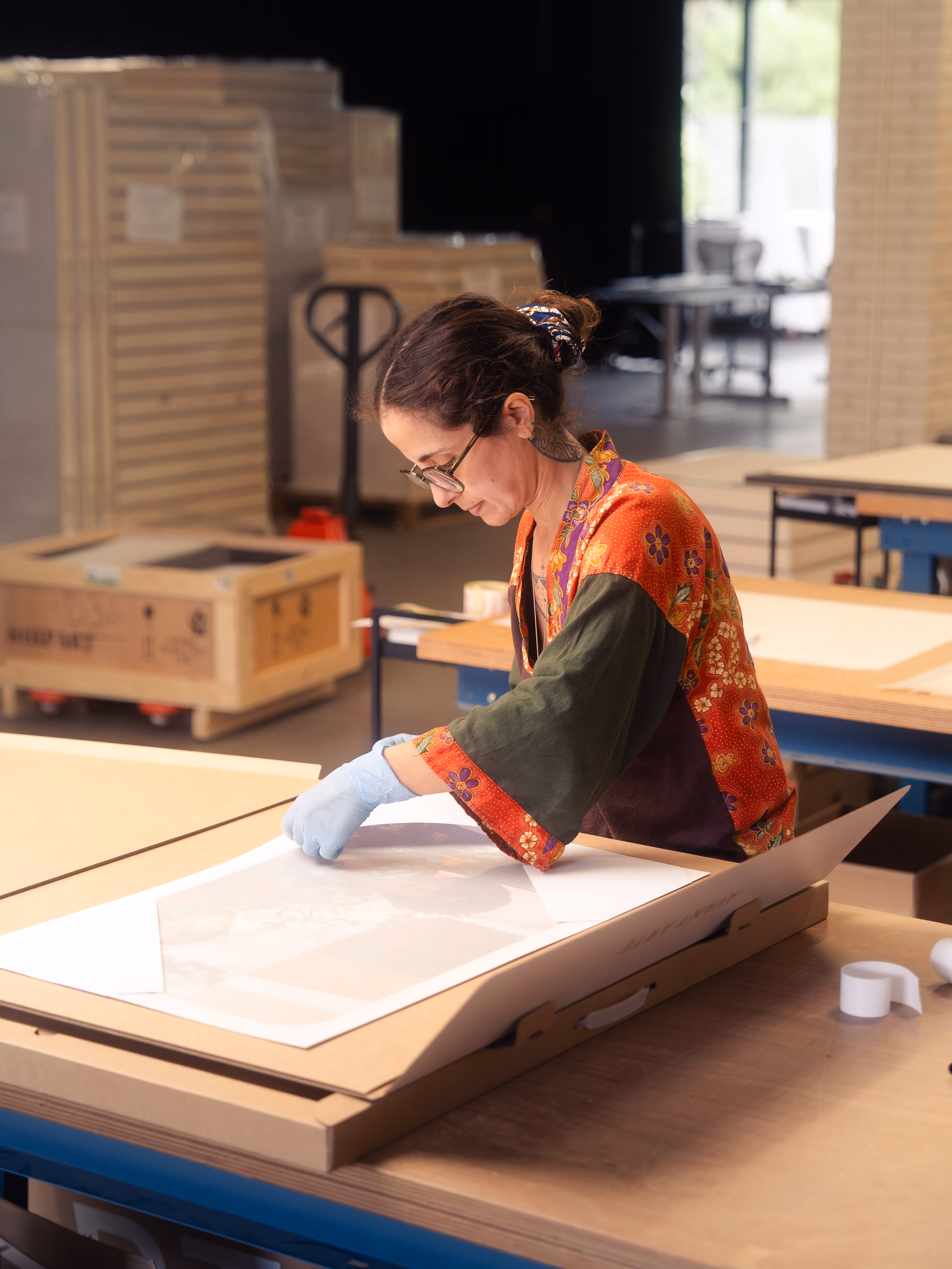 Person packing an artwork into an Avant Arte packaging box