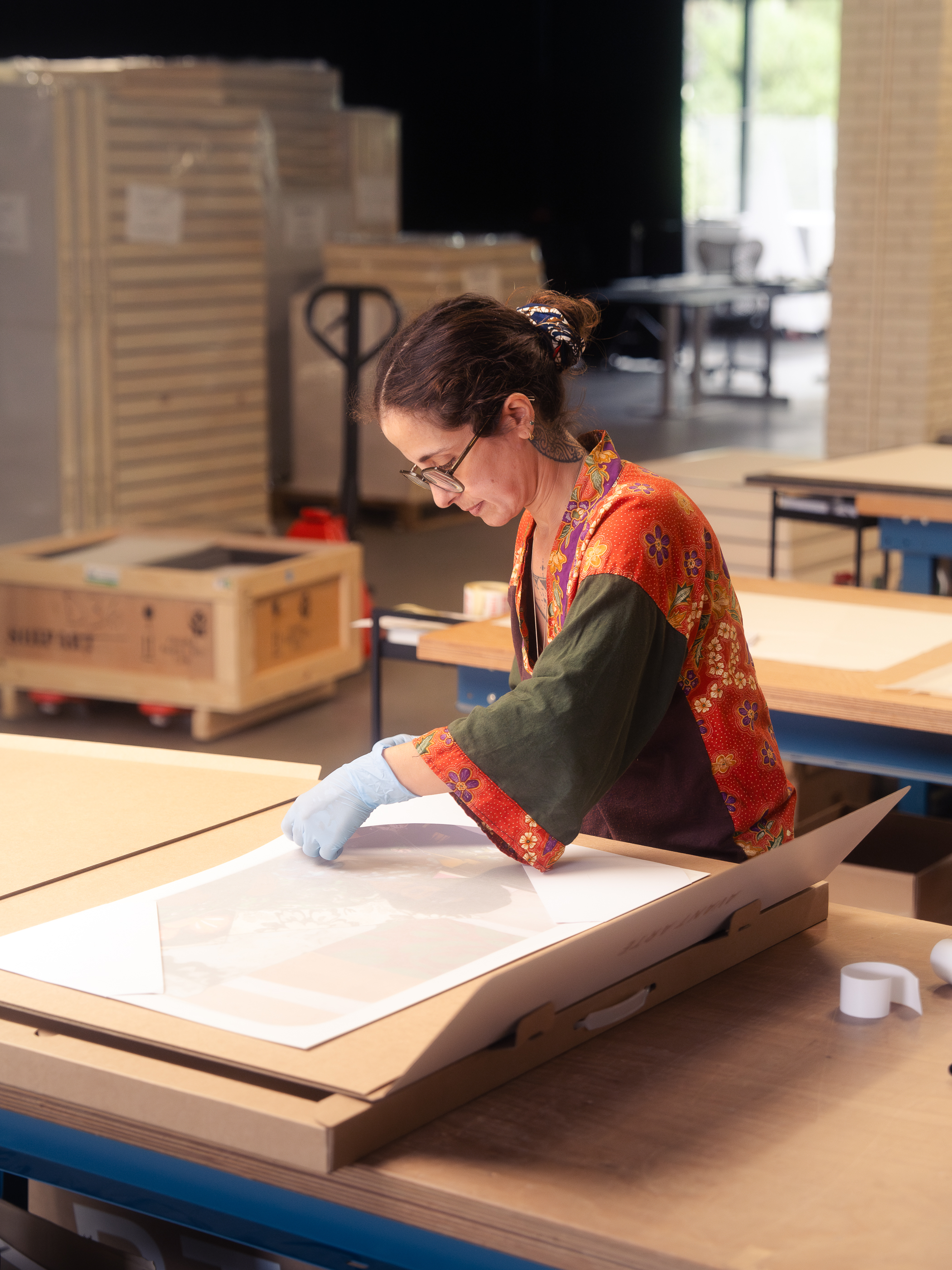 Person packing an artwork into an Avant Arte packaging box