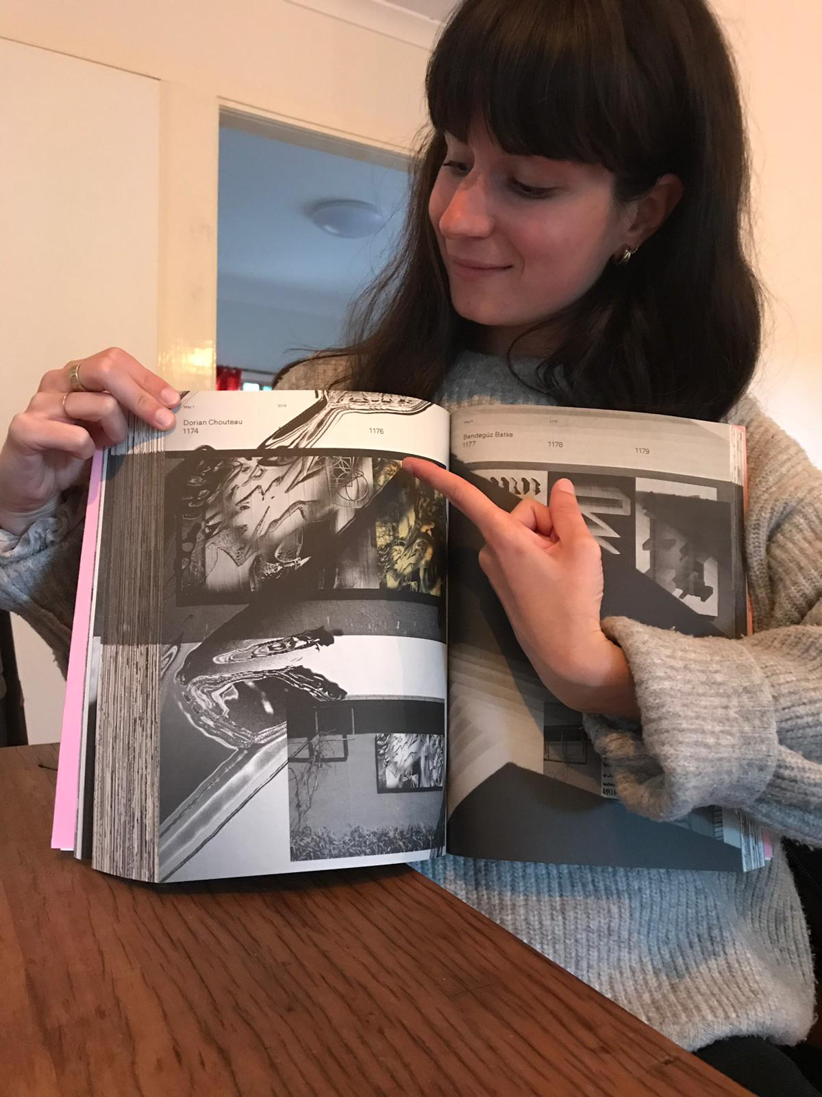 Woman holding the Ficciones Typografika book
